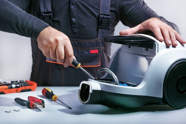 Repairman repairing vacuum cleaner.