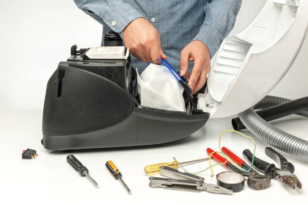 Repairman repairing of vacuum cleaner
